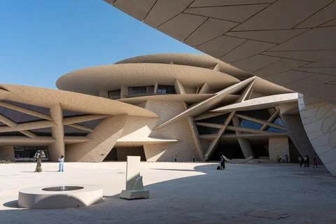 Visitors exploring interlocking discs of desert rose architecture at NMOQ. Stock Photos