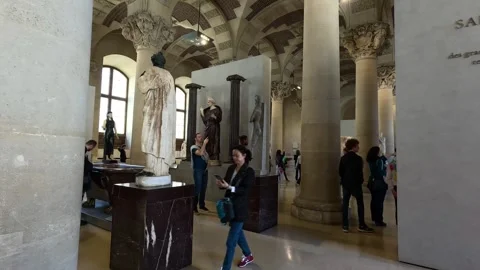 Visitors Exploring Louvre Museum Sculptures Stock Footage 296796655