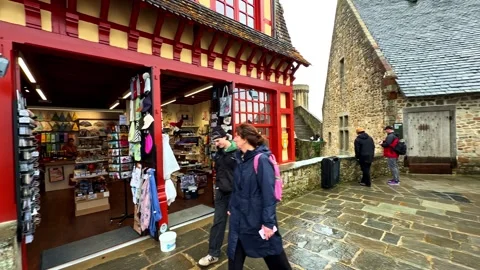 Visitors exploring medieval architecture and historic street at Mont Stock Footage 333725898