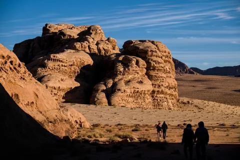 Visitors exploring sandstone formations in Wadi Rum, Jordan Stock Photos