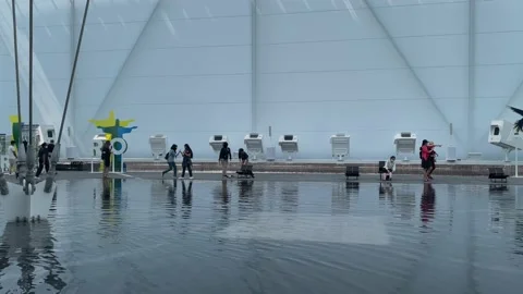Visitors exploring water feature of the Brasil pavilion at Expo 2020 Stock Footage 163091111
