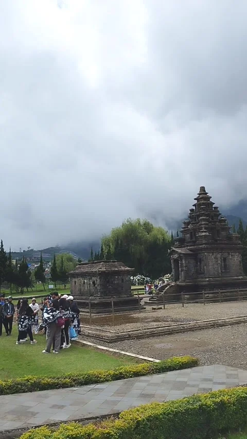 Visitors gather at Arjuna Temple complex in Dieng Plateau Stock Footage 309836289