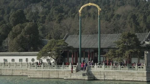 Visitors Gather at Ornate Gateway on Waterside Promenade, Summer Palace Beijing Stock Footage 341781286