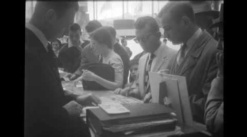 Visitors getting envelopes stamped at Brussels World's Fair Stock Footage 37595051