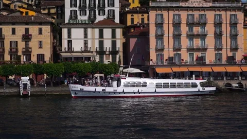 Visitors getting off sightseeing boat ship in front of Bellagio on Lake Como.  Stock Footage 125877880