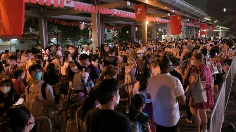 Visitors go through a long queue to enter a nighttime lantern show, which Stock Footage 239732920