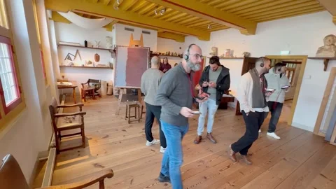 Visitors with headphones using audio guides at Rembrandt house in Amsterdam Vidéo 331857628