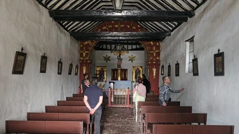 Visitors Inside Simple Whitewashed Colonial Chapel, Tabio, Colombia 8K Video stock 331511986