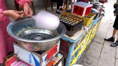 Visitors looking at a peddler making marshmarrow in New Year holidays Stock Footage 62284408