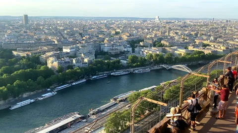 Visitors looking at the Seine river and Paris from the Eiffel Tower Stock Footage 196153857