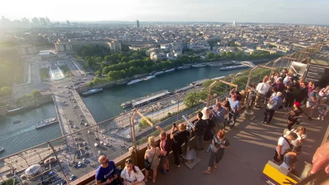 Visitors looking at the Seine river and the rooftops of Paris from Eiffel Tower Stock Footage 196153952