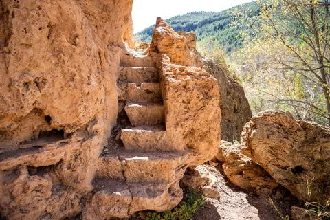 Visitors navigate path lined with ancient stone steps, leading through uniq.. Stock Photos