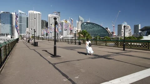 Visitors pass through Darling Harbour slow motion tracking shot 4K Video stock 170471103