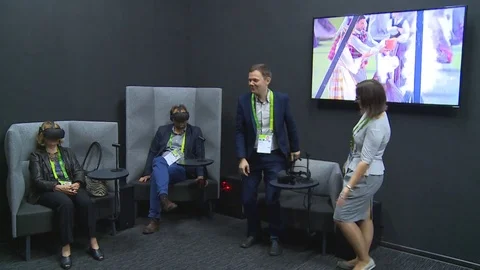 Visitors people with virtual reality headset glasses enjoy show and female guide Stock Footage 78595367