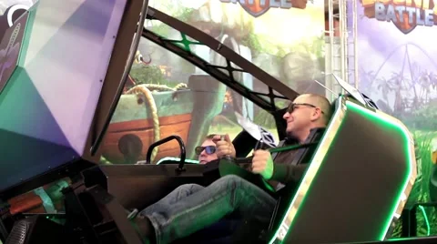 Visitors playing on redemption video simulator game Stock Footage 59548185