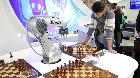 Visitors playing robot chess in game center Stock Footage 58967923