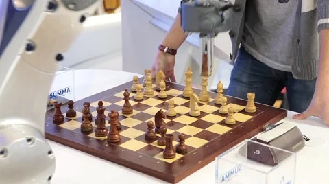Visitors playing robot chess in game center Stock Footage 64766358