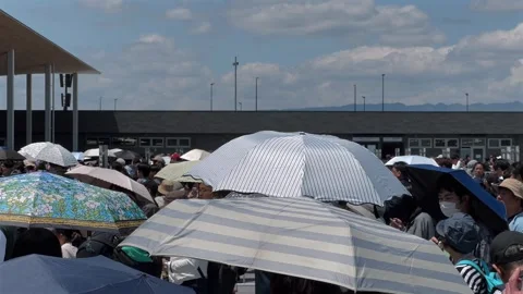 Visitors Queue Under the Summer Sun at the Entrance of Expo 2025 Osaka Video stock 320998714