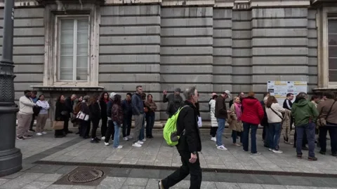 Visitors queued outside a historic public building in central Madrid, Spain Stock Footage 339375815