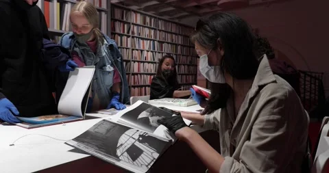Visitors reading at a table in the museum library Stock-Footage 135603056