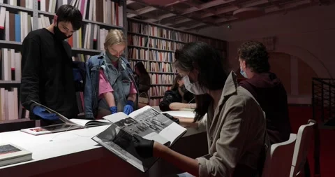 Visitors reading at a table in the museum library Stock-Footage 135603074