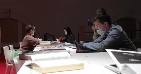 Visitors reading at a table in the museum library Stock-Footage 135603121