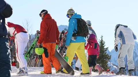 Visitors remove and return their skis and snowboards at the mountain summit Stock Footage 123954407