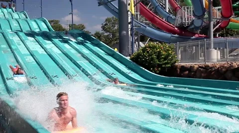 Visitors riding on Super 8 Aqua Racer in Wet'n'Wild Gold Coast water park. Stock Footage 64020760