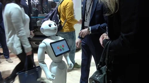 Visitors shaking hands with humanoid robot on exhibition Cebit 2017 in Hannover Stock Footage 74364562