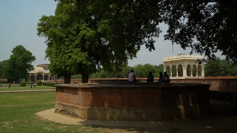 Visitors sit under the shade of trees. Video stock 107669696