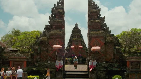 Visitors at split gate , Pura Puseh Desa Batuan, Bali 動画素材 336514811