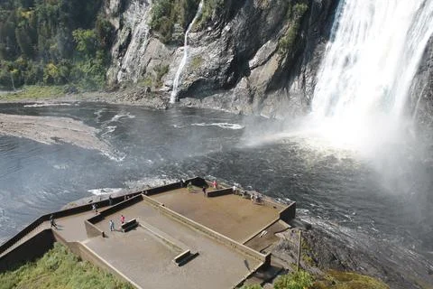 Visitors standing on viewing platform at the base of Montmorency Falls in Q.. Stock Photos