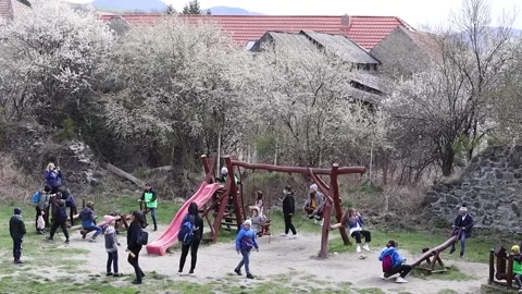 Visitors to Sukosd Bethlen castle enjoying the small playgrounds Stock Footage 186748057