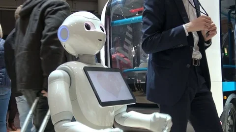 Visitors talking with humanoid robot on exhibition Cebit 2017 in Hannover Messe Stock Footage 76876426