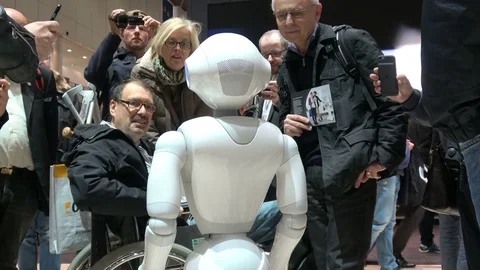 Visitors talking with humanoid robot on exhibition Cebit 2017 in Hannover Messe Stock Footage 80999948