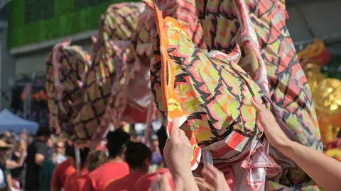 Visitors touch the tail of the dragon for good fortune at Chinese new year event Stock-Footage 124023453