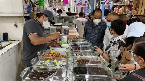 Visitors try insects and other exotic foods in San Juan Market, Mexico City 4K Stock Footage 159767156