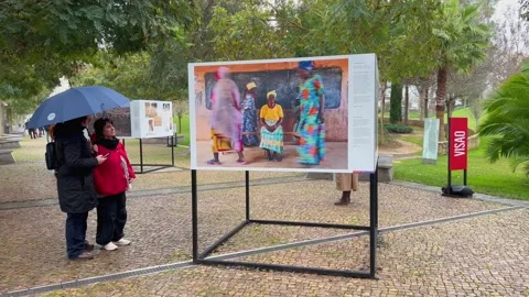 Visitors with Umbrella Viewing World Press Photo Free Exhibition in Park Oeiras Stock Footage 261594795