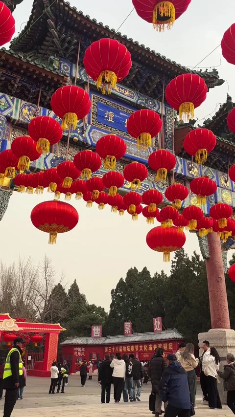 Visitors under Red lanterns at Temple of Earth during Lunar New Year Stock Footage 329847362