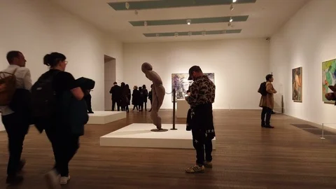 Visitors view the Dorothea Tanning exhibition at the Tate Modern in London, UK Stock Footage