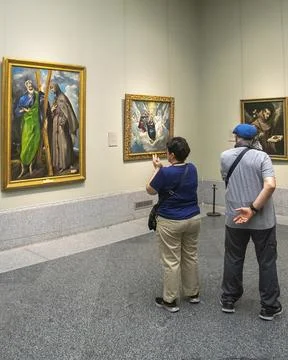 Visitors viewing artwork inside a Prado Madrid museum Stock Photos
