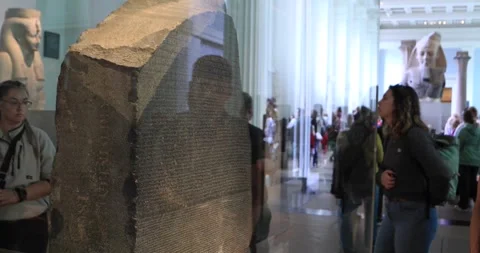 Visitors viewing the Rosetta Stone behind glass at the British Museum Stock Footage 321020330