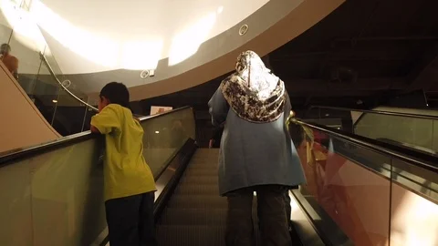 Visitors walk in large supermarkets using escalators Stock Footage 105394795