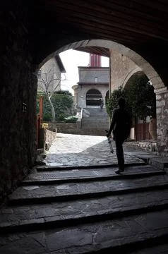 Visitors walk on stone paths in Meteora town Stock Photos