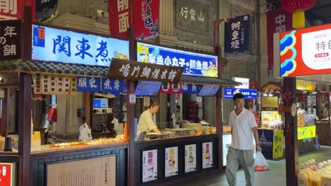 Visitors Walk Through a Bright Indoor Food Street in Dandong China Stock Footage 340175987