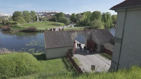 Visitors walk through the historic gate of Kastellet beside the moat Stock Footage 341289180