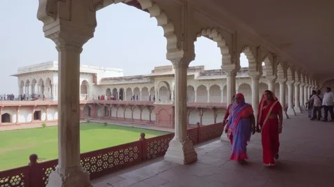 Visitors walking along long passageway of the Agra Fort, India Stock Footage 101419857