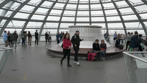 Visitors walking around architectural landmark Reichstag glass dome Stock Footage 344298176