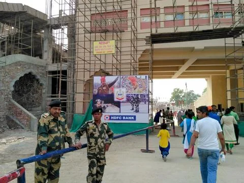 Visitors walking out from the exit gate of compound after flag lowering ceremony Stock Photos