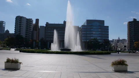 Visitors walking through of the Hiroshima Peace Memorial Park in Japan Stock Footage 335545012